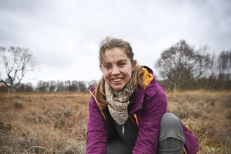 Elspeth holding soil in a wetland