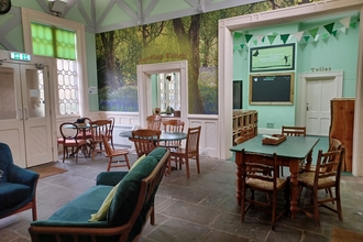 Whistlestop Community Hub chairs and tables in a room over looking a kitchen