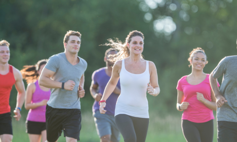 a group of people running through a park