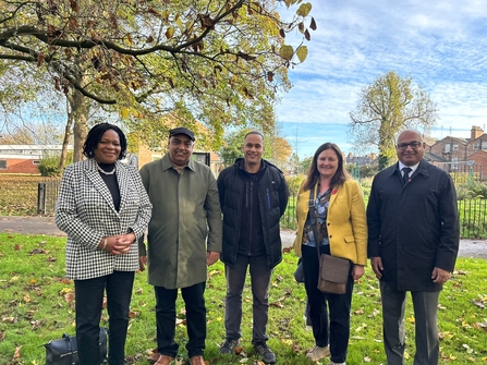 Councillor Cecile Wright, Councillor Gulfraz Nawaz, Community Organiser, Adam Dosunmu Slater, Eilish McGuinness, Chief Executive, The National Lottery Heritage Fund, Councillor Baggy Shanker stood together in a park